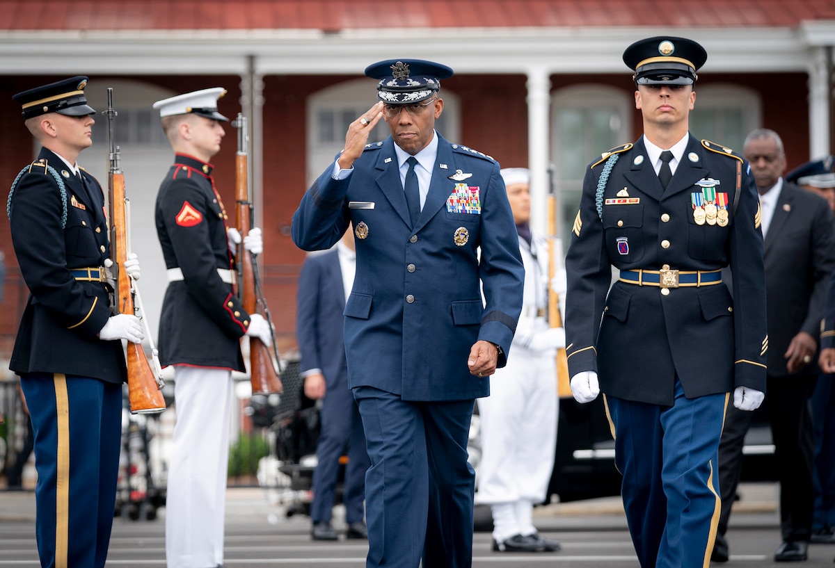 A person in uniform salutes.