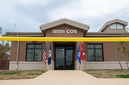 Yellow ribbon displayed in front of building for ribbon cutting.