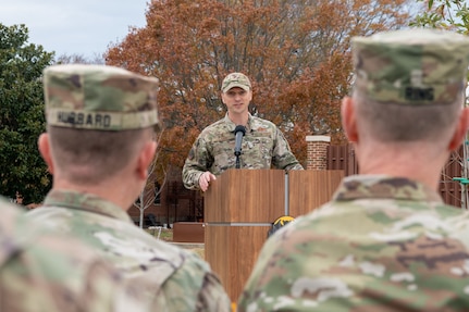 Col Lange at standing at podium talking to audience.