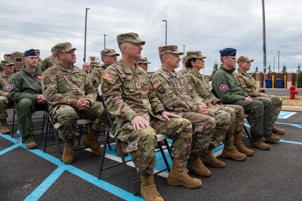 Military members sitting in audience.