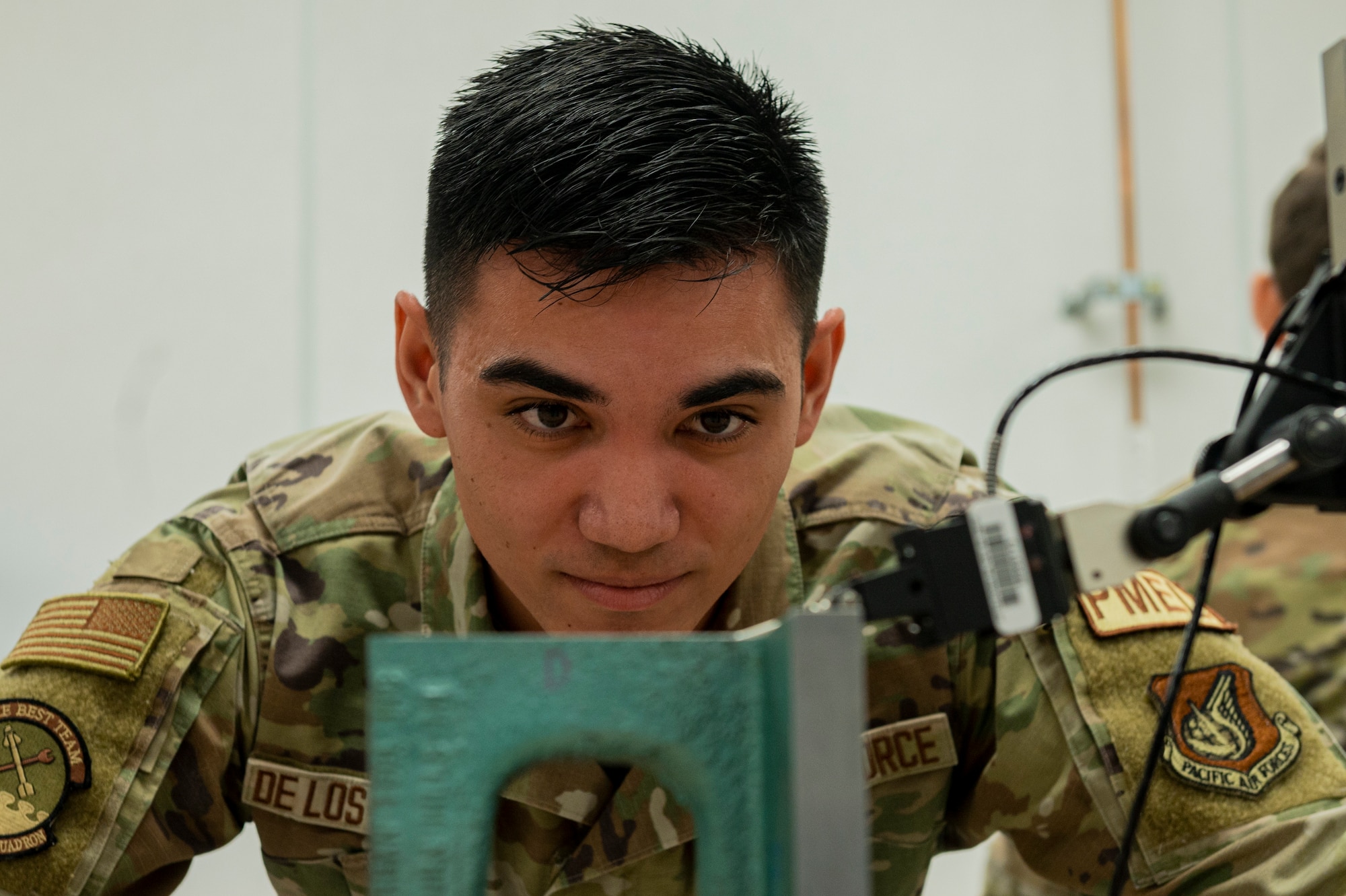 U.S. Air Force Senior Airman Bryant De Los Reyes, 51st Maintenance Squadron precision measurement equipment laboratory logistics technician, compares the parallelism of an angle iron at Osan Air Base, Republic of Korea, Dec. 15, 2023. PMEL plays a fundamental role in keeping Osan’s tools safe, efficient, accurate and reliable. (U.S. Air Force Senior Airman Kaitlin Castillo)