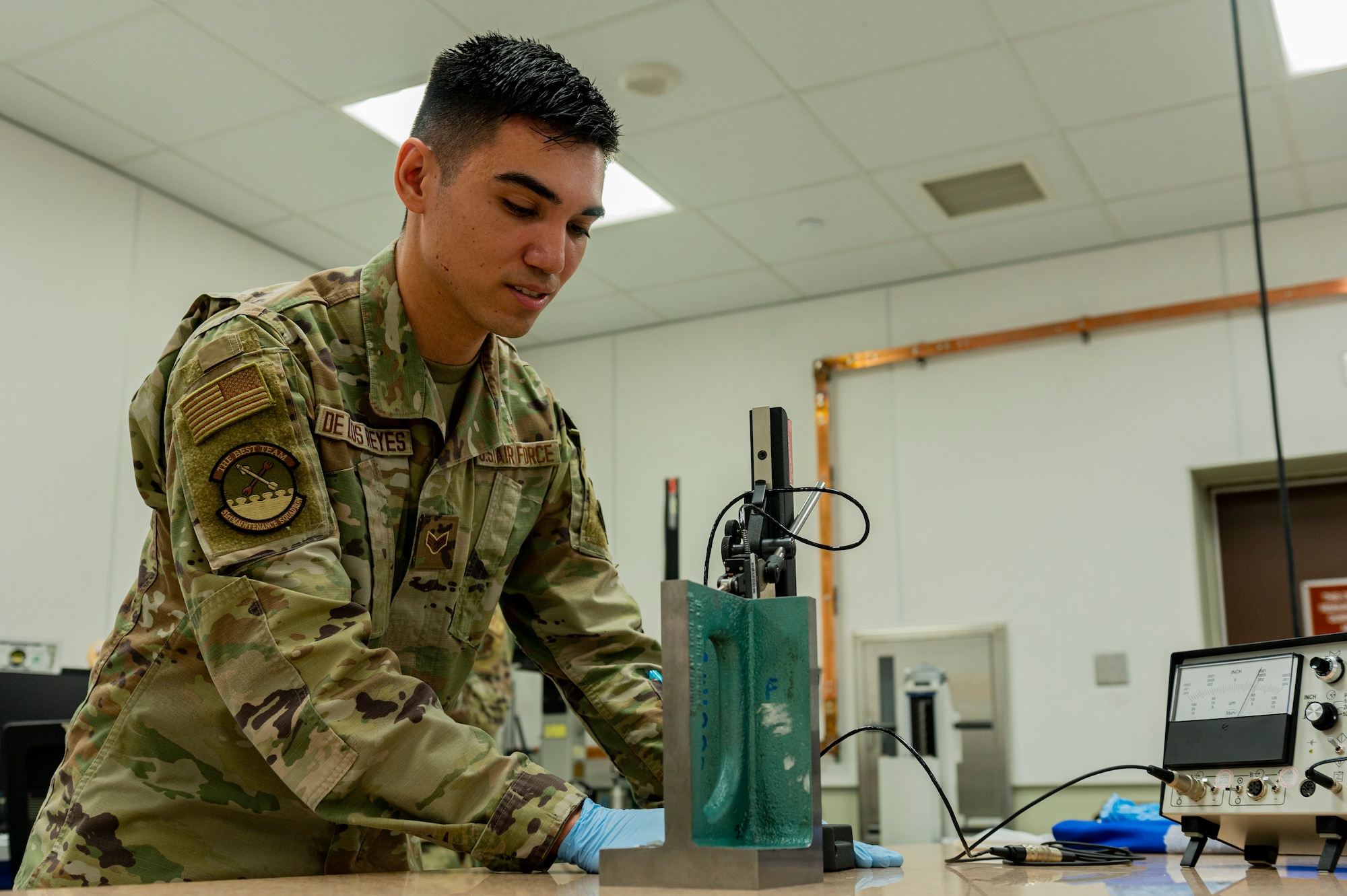 U.S. Air Force Senior Airman Bryant De Los Reyes, 51st Maintenance Squadron precision measurement equipment laboratory logistics technician, compares the parallelism of an angle iron at Osan Air Base, Republic of Korea, Dec. 15, 2023. The PMEL flight services more than 100 organizations at Osan and across the ROK. (U.S. Air Force photo by Senior Airman Kaitlin Castillo)