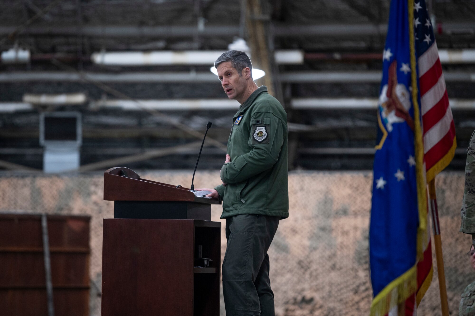 U.S. Air Force Col. William McKibban, 51st Fighter Wing commander, gives a speech during the 25th Fighter Generation Squadron Dedicated Crew Chief Ceremony at Osan Air Base, Republic of Korea, Dec. 19, 2023.