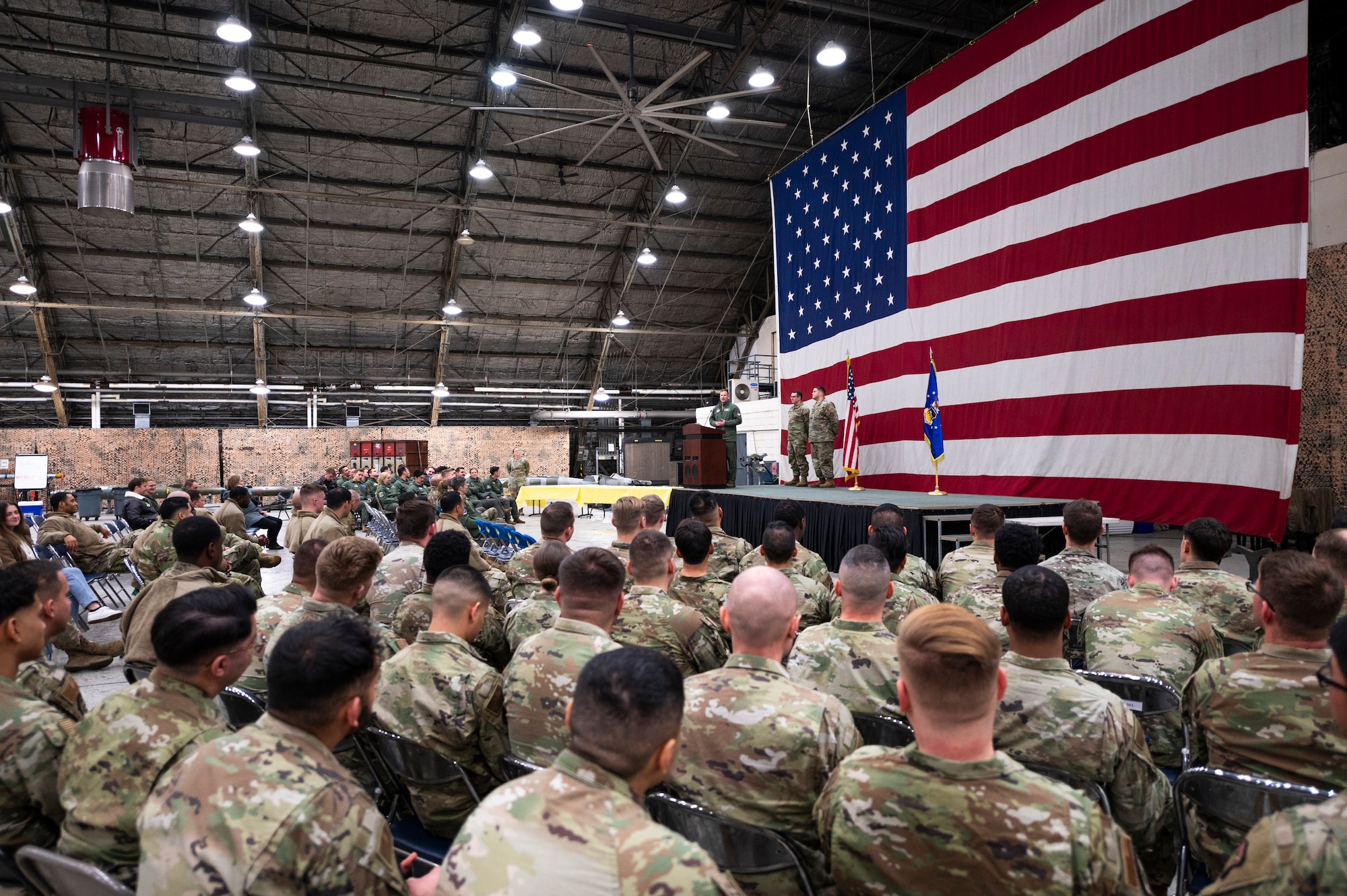 U.S. Airmen from the 51st Fighter Wing sit in attendance during the 25th FGS Dedicated Crew Chief Ceremony at Osan Air Base, Republic of Korea, Dec. 19, 2023.