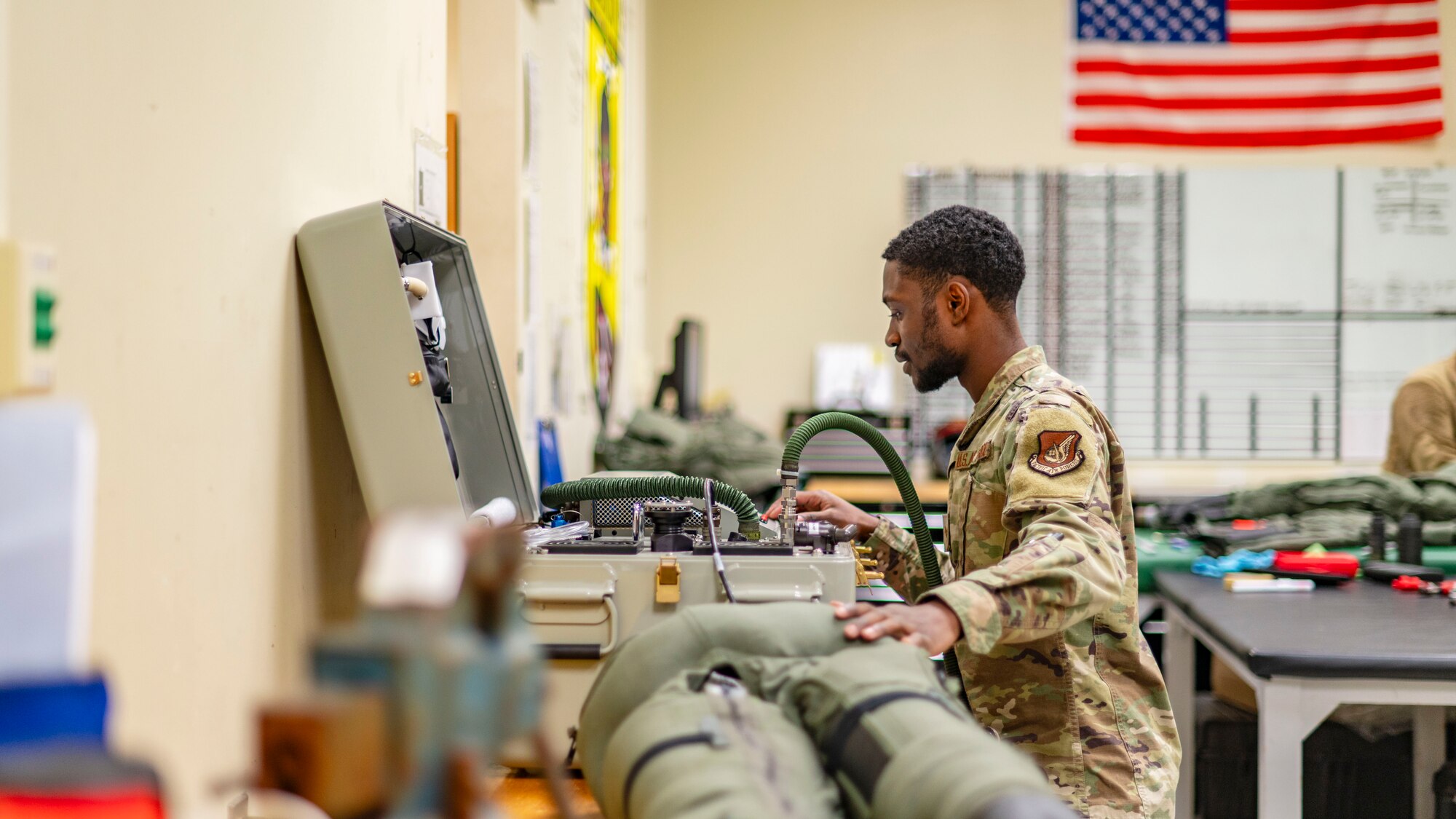 SrA Jamarius Paige, aircrew flight equipment journeyman, identifies potential leaks on a g-suit during a routine inspection at Kunsan Air Base