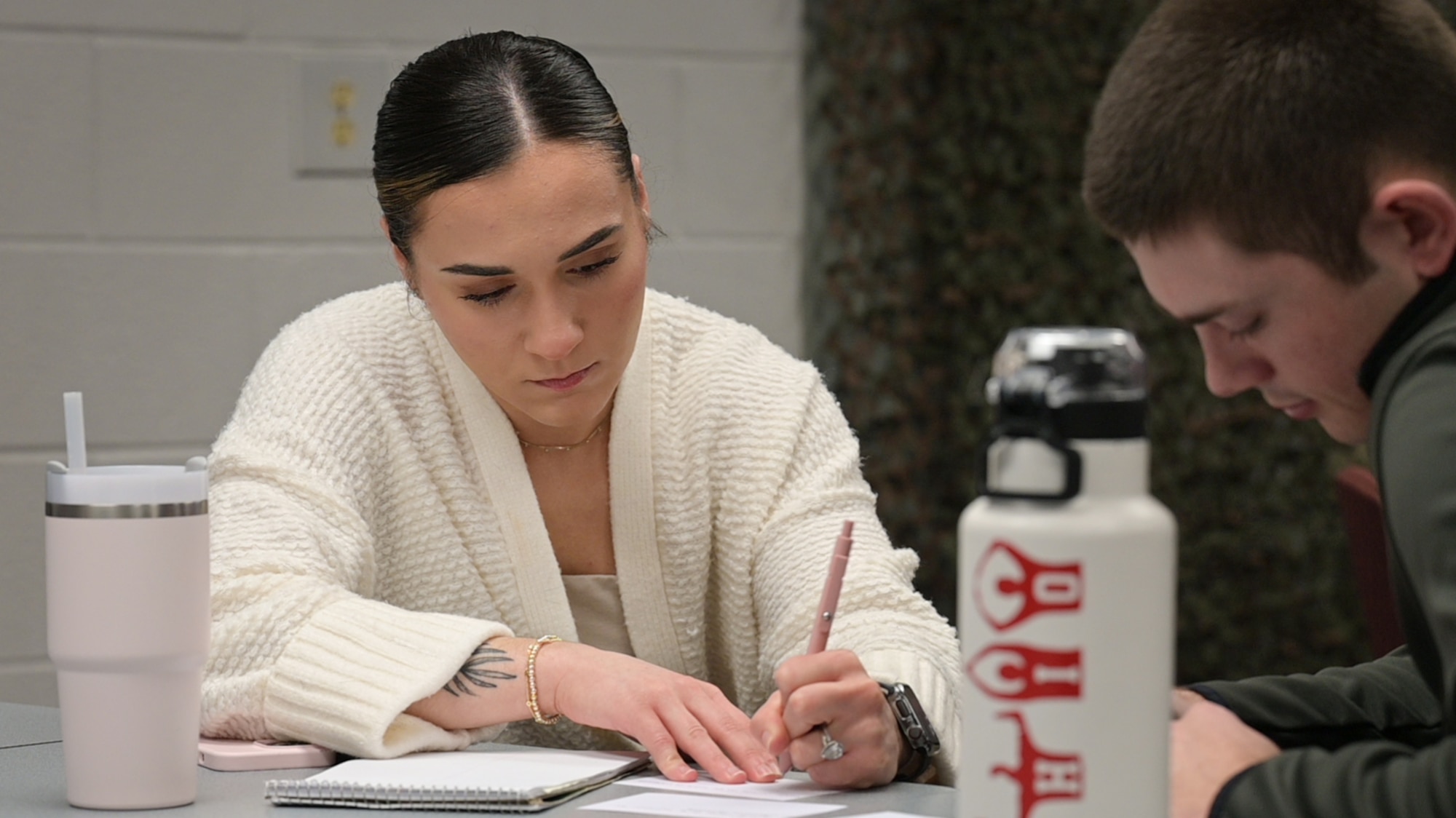 Woman writes on a piece of paper.