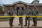 The Virginia Air National Guard’s 185th Cyberspace Operations Squadron, 192nd Operations Group, 192nd Wing, holds a ribbon-cutting ceremony for the opening of its state-of-the-art cyberspace facility Dec. 1, 2023, at Joint Base Langley-Eustis in Hampton, Virginia. From left to right, Maj. Gen. James W. Ring, adjutant general of Virginia; the youngest Bat, a 185th COS senior Airman; Col. Brock E. Lange, 192nd Wing commander; and Chief Master Sgt. Sean J. Fretwell, 192nd Wing command chief, stood in front of the building as the youngest Bat cut the ribbon.