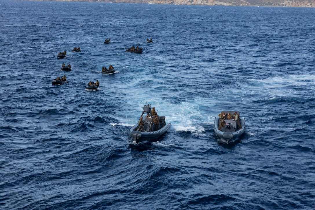 U.S. Marines from the 26th Marine Expeditionary Unit (Special Operations Capable) prepare to start a small-scale amphibious assault alongside Greek Marines with 32nd Hellenic Marine Brigade during a bilateral exercise near Skyros, Greece, Dec. 2, 2023. U.S. Marines and Sailors of the 26th Marine Expeditionary Unit (Special Operations Capable), embarked on the ships of the Bataan Amphibious Ready Group, are on a scheduled deployment as the Tri-Geographic Combatant Command crisis response force with elements deployed to the U.S. 5th Fleet and U.S. 6th Fleet areas of operation to increase maritime security and stability, and to defend U.S., Allied, and Partner interests. (U.S. Marine Corps photo by Staff Sgt. Jesus Sepulveda Torres)
