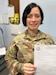 Sergeant 1st Class Ashley Hackley, training supervisor for HHC, Army Reserve Aviation Command, at Fort Knox, Kentucky, holds up her test results depicting the perfect 144 she scored on her March 22, 2023 Armed Forces Classification Test. She credits much of her success to the Basic Skills Education Program, a monthlong refresher course that prepares Soldiers to take the AFCT.