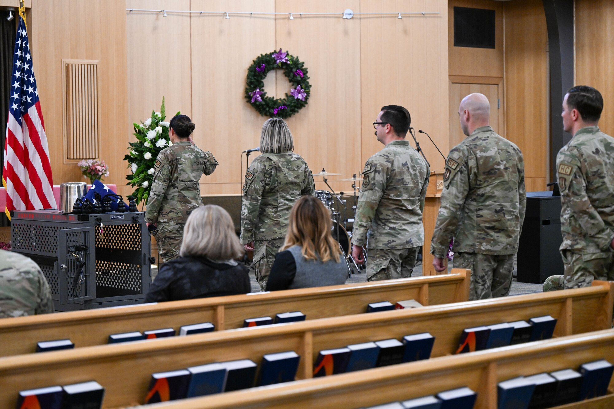 Airmen line up to salute the “missing dog display” at the memorial service for military working dog Xxuthus