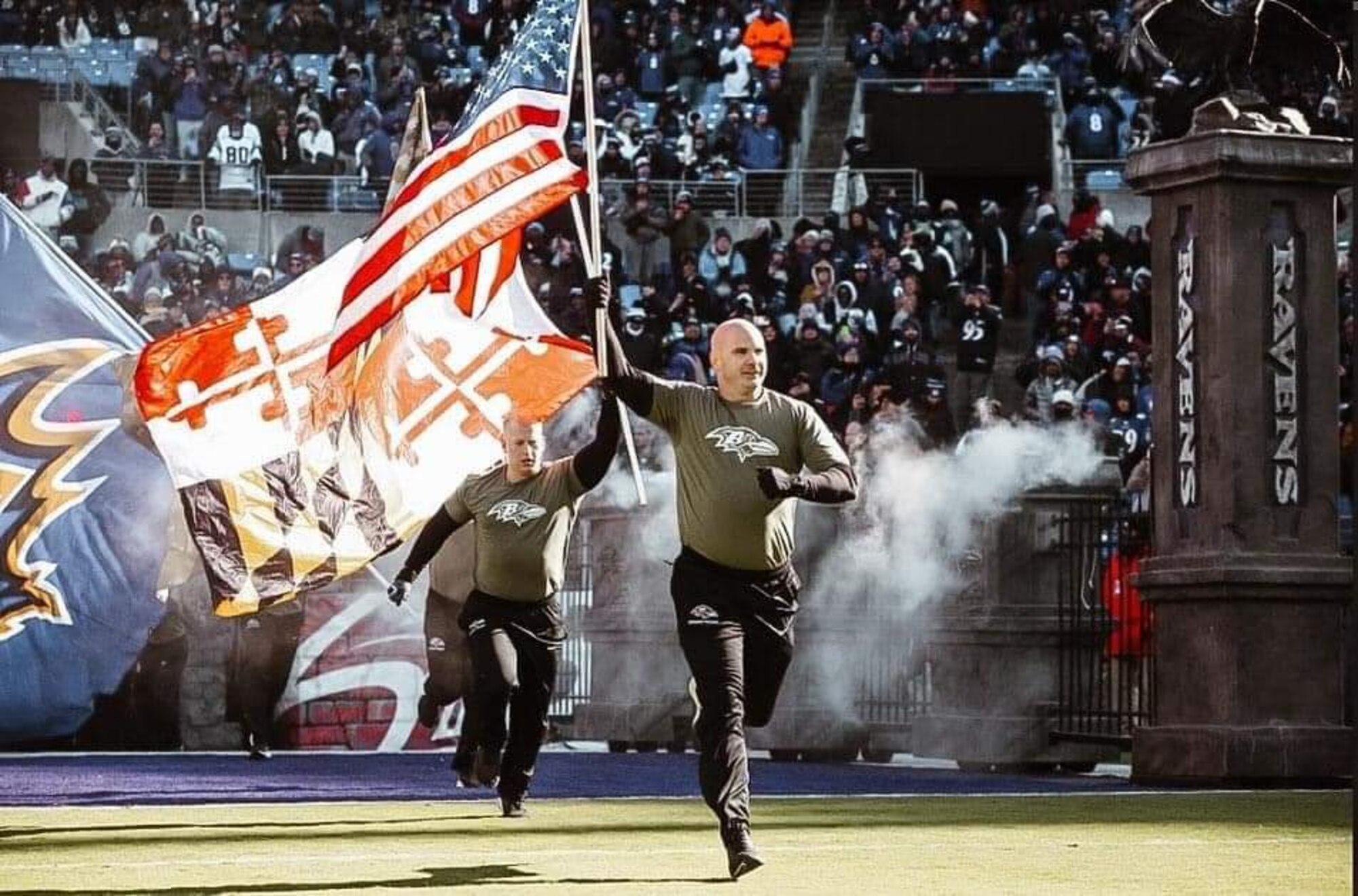 Nathan Curl, Baltimore Ravens cheerleader, runs with the U.S. flag during a National Football League game, Nov. 20, 2022, at the M&T Bank Stadium, Baltimore, Maryland. Curl is an active duty member in the U.S. Air Force and serves as the director of operation for the 29th Intelligence Squadron, Fort George G. Meade, Maryland. (Courtesy photo)
