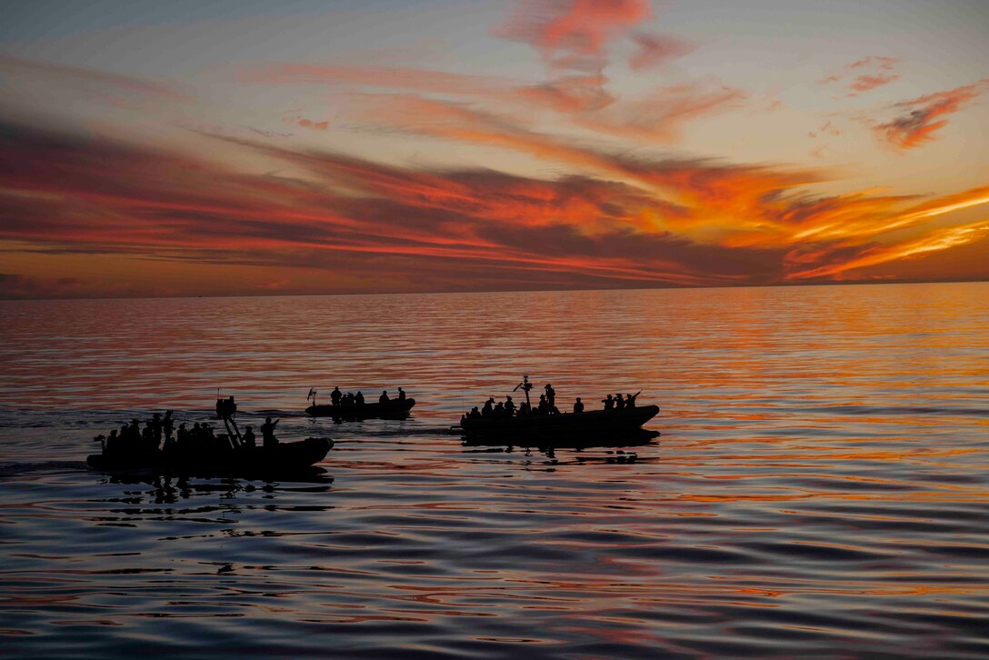 U.S. Marines and Sailors assigned to Reconnaissance Company, 15th Marine Expeditionary Unit, and the amphibious dock landing ship USS Harpers Ferry (LSD 49), operate rigid-hull inflatable boats during a visit, board, search, and seizure training mission in the Pacific Ocean, Dec. 11, 2023. The 15th MEU is currently embarked aboard the Boxer Amphibious Ready Group conducting integrated training and routine operations in U.S. 3rd Fleet. (U.S. Marine Corps photo by Sgt. Patrick Katz)