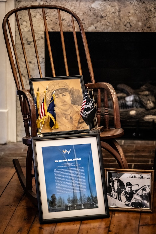 A collection of mementos decorate a ceremony in Cynthiana, Ky., Nov. 13, 2023, to present a posthumous Prisoner of War Medal to the family of U.S. Air Force Brig. Gen. Jack Henry Owen. Owen, who served in the Kentucky Air National Guard for more than 24 years, rising to become assistant adjutant general for Air, was piloting a B-17 Flying Fortress over Hamburg, Germany, on July 25, 1943, when the aircraft was shot down, and he remained a POW for the duration of World War II. The pencil sketch was drawn by his father, Sterling Owen Jr., and the rocking chair was a favorite of General Owen’s. (U.S. Air National Guard photo by Dale Greer)