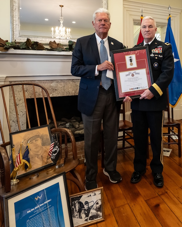 U.S. Army Maj. Gen. Haldane Lamberton, right, adjutant general of the Kentucky National Guard, presents a posthumous Prisoner of War Medal to Sterling P. Owen IV on behalf of Owen’s late uncle, U.S. Air Force Brig. Gen. Jack Henry Owen, during a ceremony in Cynthiana, Ky., Nov. 13, 2023. General Owen, who served in the Kentucky Air National Guard for more than 24 years, rising to become assistant adjutant general for Air, was piloting a B-17 Flying Fortress over Hamburg, Germany, on July 25, 1943, when the aircraft was shot down. He and his crewmen safely parachuted to the ground but were captured by German forces, and Owen remained a POW for the duration of World War II. (U.S. Air National Guard photo by Dale Greer)