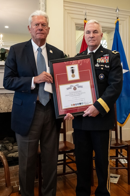 U.S. Army Maj. Gen. Haldane Lamberton, right, adjutant general of the Kentucky National Guard, presents a posthumous Prisoner of War Medal to Sterling P. Owen IV on behalf of Owen’s late uncle, U.S. Air Force Brig. Gen. Jack Henry Owen, during a ceremony in Cynthiana, Ky., Nov. 13, 2023. General Owen, who served in the Kentucky Air National Guard for more than 24 years, rising to become assistant adjutant general for Air, was piloting a B-17 Flying Fortress over Hamburg, Germany, on July 25, 1943, when the aircraft was shot down. He and his crewmen safely parachuted to the ground but were captured by German forces, and Owen remained a POW for the duration of World War II. (U.S. Air National Guard photo by Dale Greer)