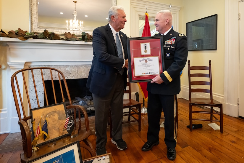 U.S. Army Maj. Gen. Haldane Lamberton, right, adjutant general of the Kentucky National Guard, presents a posthumous Prisoner of War Medal to Sterling P. Owen IV on behalf of Owen’s late uncle, U.S. Air Force Brig. Gen. Jack Henry Owen, during a ceremony in Cynthiana, Ky., Nov. 13, 2023. General Owen, who served in the Kentucky Air National Guard for more than 24 years, rising to become assistant adjutant general for Air, was piloting a B-17 Flying Fortress over Hamburg, Germany, on July 25, 1943, when the aircraft was shot down. He and his crewmen safely parachuted to the ground but were captured by German forces, and Owen remained a POW for the duration of World War II. (U.S. Air National Guard photo by Dale Greer)