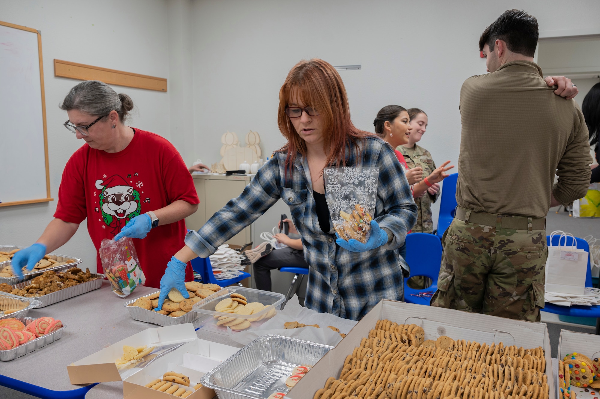 Volunteers sort cookies at Dyess Air Force Base, Texas, Dec. 18, 2023. Cookies were sorted into boxes to support Operation Cookie Drop, an annual program where cookies are sorted and delivered to 725 dorm Airmen. (U.S. Air Force photo by Airman 1st Class Alondra Cristobal Hernandez)