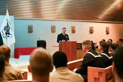 Cmdr. Peter Manzoli, commanding officer, Information Warfare Training Command (IWTC) Corry Station, addressed the students and audience for the graduation of the first group of Computer Network Operator Qualification Course (CNOQC) students taught at IWTC Corry Station on Dec. 22, 2023.