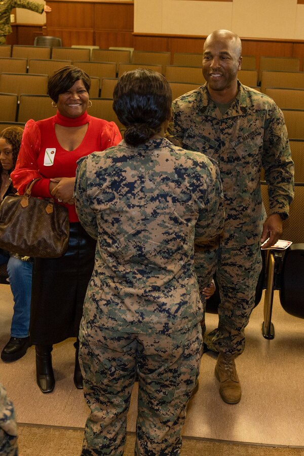 A U.S. Marine with 4th Marine Logistics Group congratulates Sgt. Maj. Christopher Thomas, the outgoing sergeant major of 4th Marine Logistics Group, on his retirement during a relief and appointment ceremony on Marine Corps Support Facility, New Orleans, Dec. 19, 2023. Thomas was relieved from his appointment by Sgt. Maj. Patrick Fay. Thomas is a Franklin, Louisiana native and retired with 29 years of service. (U.S. Marine Corps photo by Lance Cpl. Sarah Pysher)