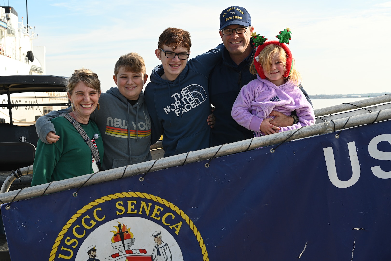 U.S. Coast Guard Capt. James McCormack, the commanding officer of U.S. Coast Guard Cutter Seneca (WMEC 906), poses for a photo with his family at the cutter's return to homeport in Portsmouth, Virginia, Dec. 22, 2023, following a 65-day patrol in the Western Caribbean and Eastern Pacific Ocean. Patrolling in support of Joint Interagency Task Force-South, Seneca worked alongside other Coast Guard cutters, Department of Defense and Department of Homeland Security units, and international partners to conduct maritime safety and security missions.