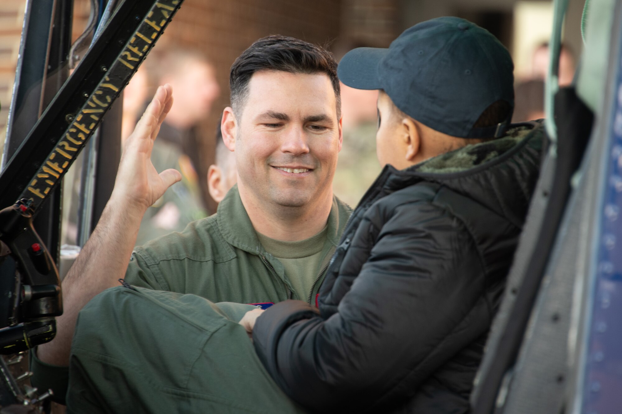 U.S. Air Force Master Sgt. Jesse McCarley, left, 121st Fighter Squadron aircrew flight equipment flight chief, interacts with “Pilot for a Day” participant Jeremiah Hawkins at Joint Base Andrews