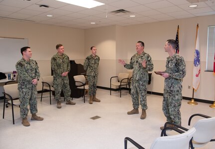 231218-N-DQ752-1013 JOINT BASE SAN ANTONIO FT. SAM HOUSTON, Texas (Dec. 18, 2023) Rear Adm. Walter Brafford, commander, Naval Medical Forces Support Command, presents Hospital Corpsman 1st Class Richard Kidwell, an instructor assigned to Navy Medicine Training Support Center, with the Behavioral Health Technician of the Year award in Smith Hall, Dec. 18. NMTSC is the Navy component command that provides administrative and operational control over Navy staff and students assigned to the Medical Education and Training Campus and other medical programs in the San Antonio area. (U.S. Navy Photo by Mass Communication Specialist 2nd Class Cheyenne Geletka/Released)
