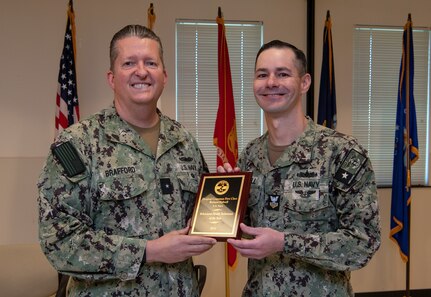 231218-N-DQ752-1012 JOINT BASE SAN ANTONIO FT. SAM HOUSTON, Texas (Dec. 18, 2023) Rear Adm. Walter Brafford, commander, Naval Medical Forces Support Command, presents Hospital Corpsman 1st Class Richard Kidwell, an instructor assigned to Navy Medicine Training Support Center, with the Behavioral Health Technician of the Year award in Smith Hall, Dec. 18. NMTSC is the Navy component command that provides administrative and operational control over Navy staff and students assigned to the Medical Education and Training Campus and other medical programs in the San Antonio area. (U.S. Navy Photo by Mass Communication Specialist 2nd Class Cheyenne Geletka/Released)