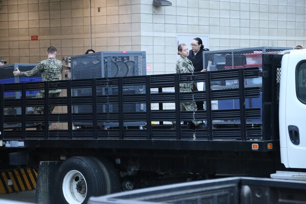 Sailors from Naval Health Clinic Lemoore load point of dispensary (POD) units onto a flatbed truck to transport the shot exercise location at the Flight Readiness Center (FRC) West aboard Naval Air Station (NAS) Lemoore.