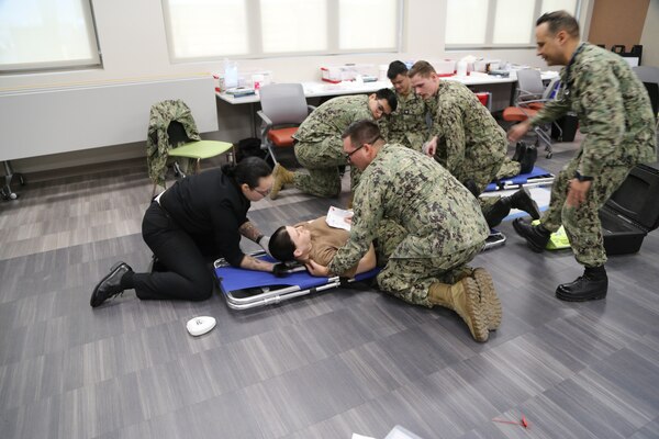 Hospital corpsmen from Naval Health Clinic Lemoore assists during the point of dispensary (POD) exercise aboard Naval Air Station Lemoore, California.  Sailors from FRC West role played and acted as patients with health-related difficulties.