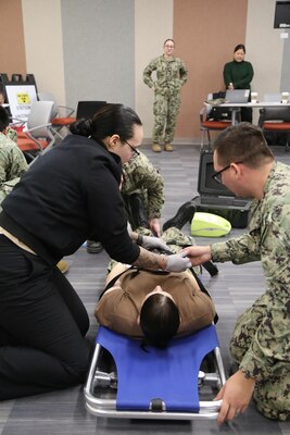 Hospital corpsmen from Naval Health Clinic Lemoore assists during the point of dispensary (POD) exercise aboard Naval Air Station Lemoore, California.  Sailors from FRC West role played and acted as patients with health-related difficulties.