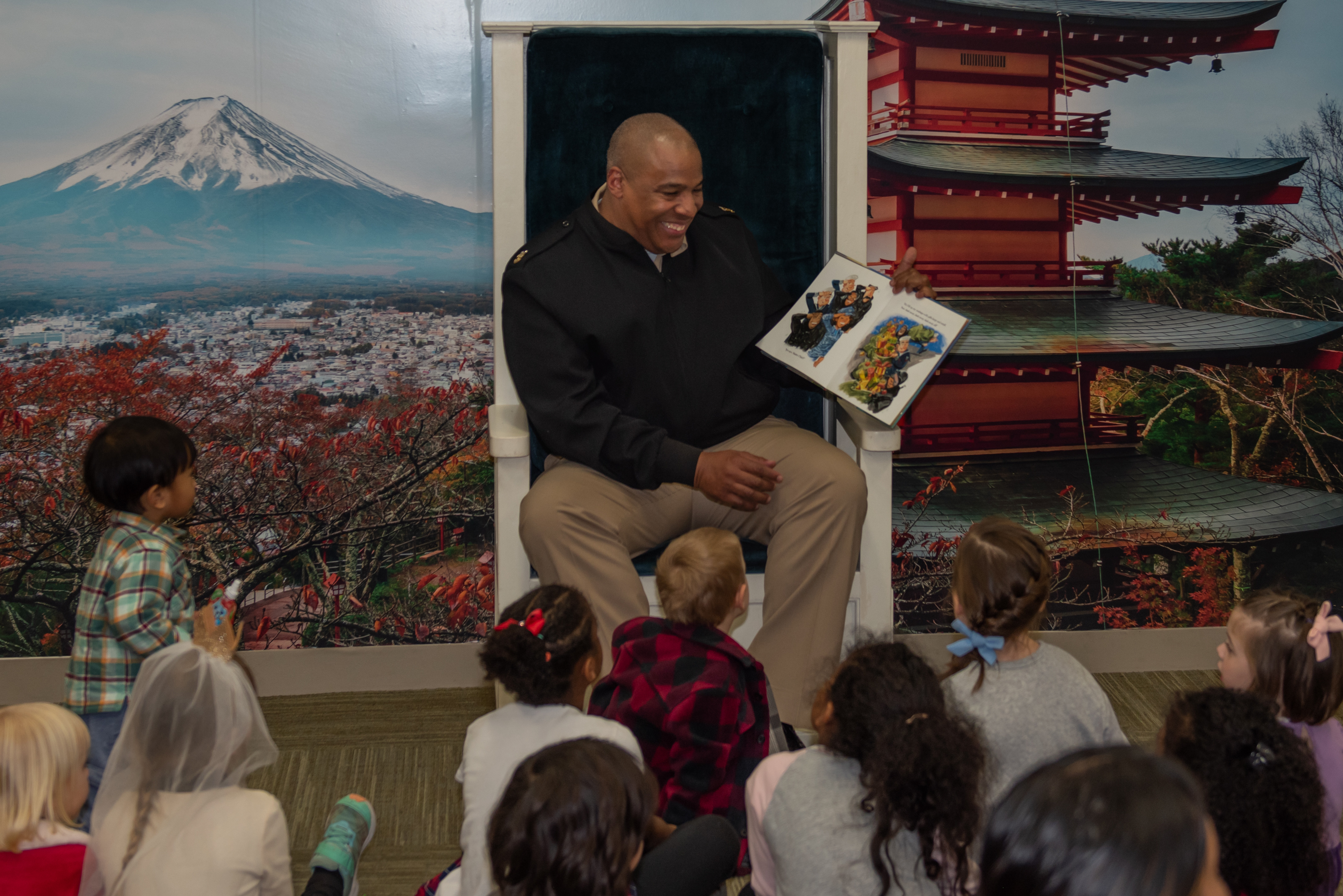 U.S. Navy Master Chief reads a storybook to children in Yokosuka, Japan.