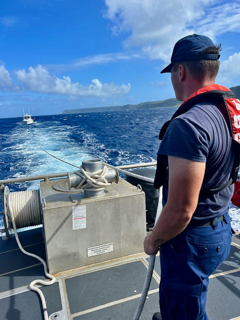 The crew of a U.S. Coast Guard 45-foot Response Boat-Medium from Station Apra Harbor tows the 28-foot recreational boat Rascal near Tanguisson Beach, Guam, on Dec. 23, 2023. In a successful search and rescue operation executed by U.S. Coast Guard Forces Micronesia/Sector Guam and Guam Fire Rescue, the recreational vessel Rascal, with six adults aboard, was safely towed to Hagåtña Boat Basin after the operator radioed in, reporting being disabled and adrift. (U.S. Coast Guard photo by Petty Officer 2nd Class William Naden)