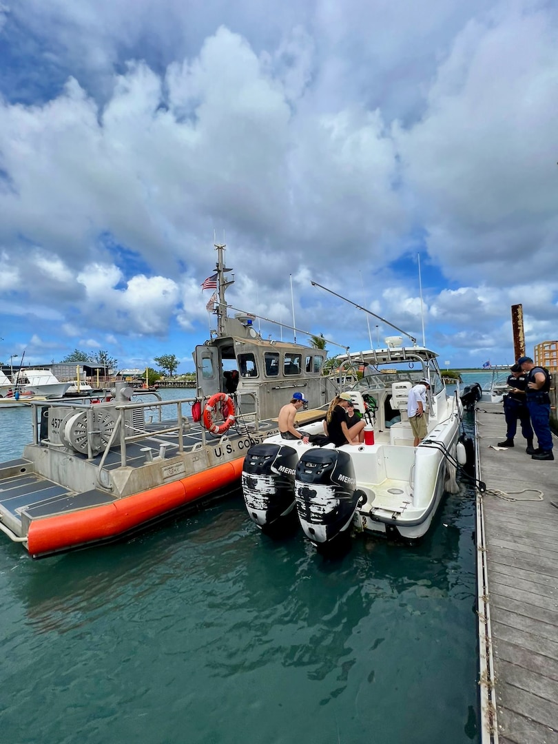 The crew of a U.S. Coast Guard 45-foot Response Boat-Medium from Station Apra Harbor tows the 28-foot recreational boat Rascal near Tanguisson Beach, Guam, on Dec. 23, 2023. In a successful search and rescue operation executed by U.S. Coast Guard Forces Micronesia/Sector Guam and Guam Fire Rescue, the recreational vessel Rascal, with six adults aboard, was safely towed to Hagåtña Boat Basin after the operator radioed in, reporting being disabled and adrift. (U.S. Coast Guard photo by Petty Officer 2nd Class William Naden)