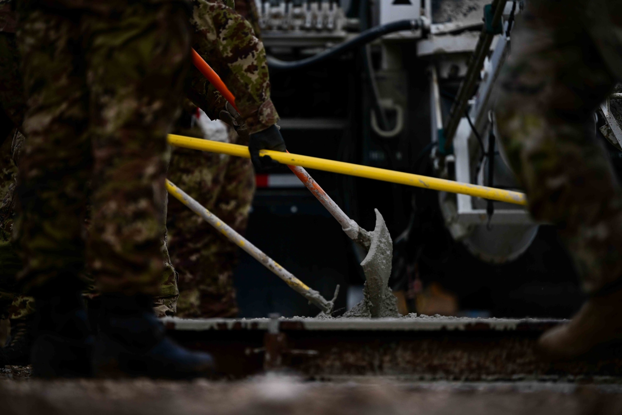 U.S Air Force Airmen assigned to Aviano combined with Italian army personnel lay concrete.