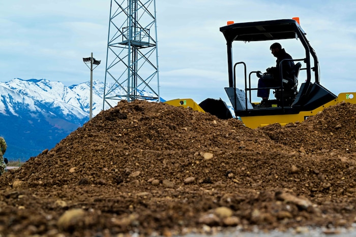 Italian army solider operates a tandem vibratory roller during a training exercise.