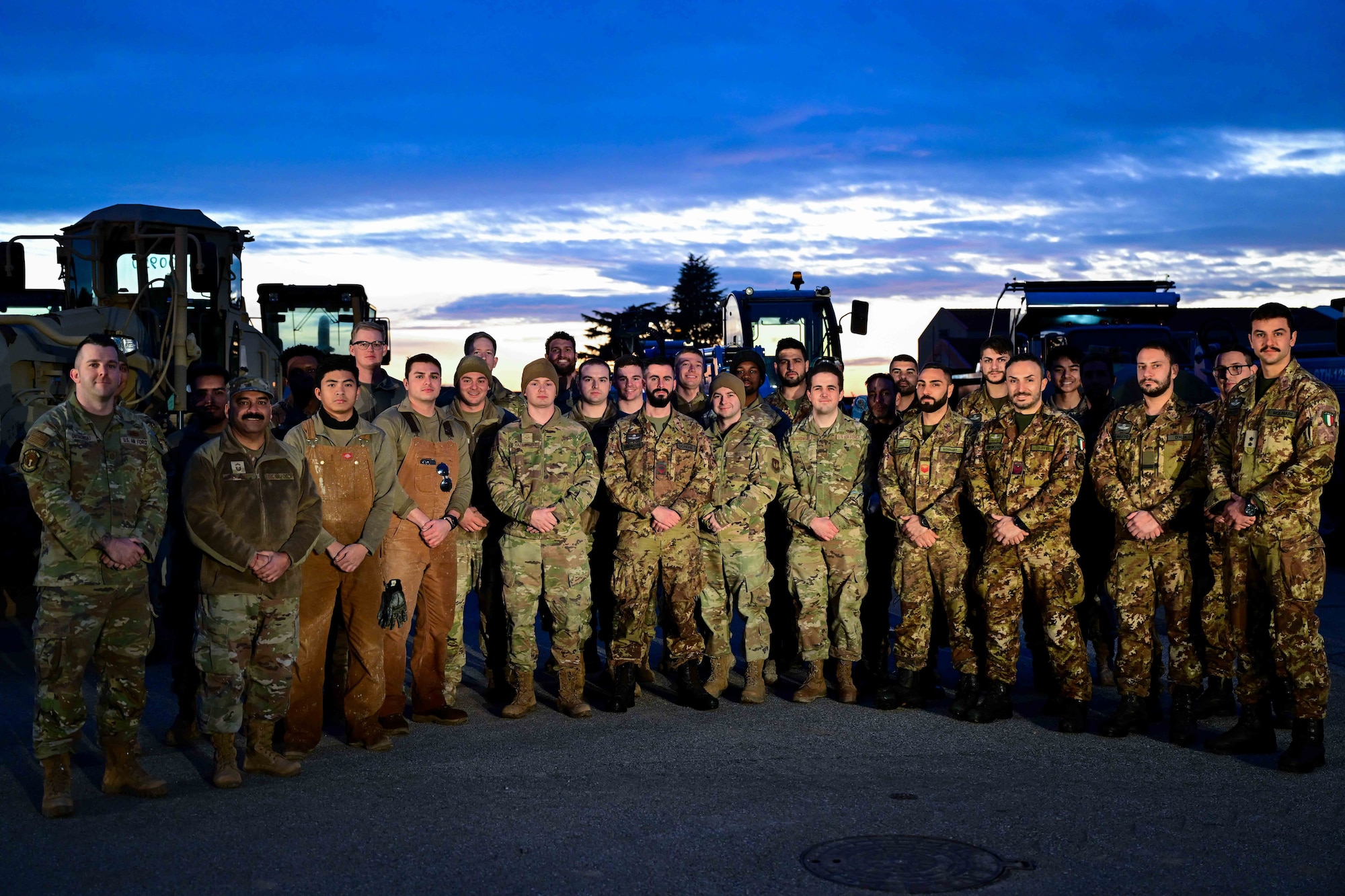 U.S. Air Force Airmen assigned to the 31st Civil Engineer Squadron and Italian army personnel pose for a group photo.