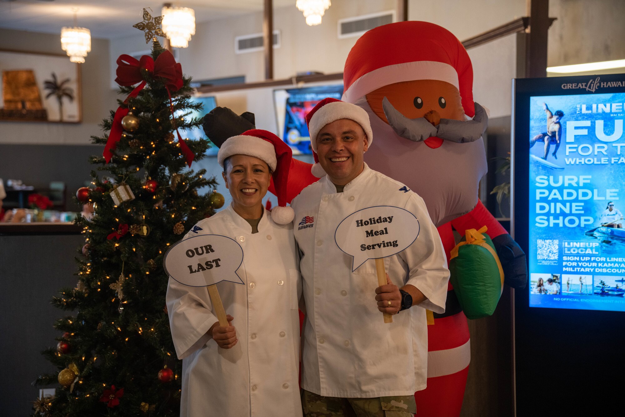 Col. Stella Garcia, 15th Medical Group commander, and Col. Andrew Garcia, 15th Maintenance Group commander, pose for a photo during Christmas Eve lunch at the Hale Aina Dining Facility on Joint Base Pearl Harbor-Hickam, Hawaii, Dec. 24, 2023.  Leaders from the 15th Wing, 515th Air Mobility Wing and 647th Air Base Group attended the event to serve Airmen and their families lunch on Christmas Eve. (U.S. Air Force photo by Senior Airman Makensie Cooper)