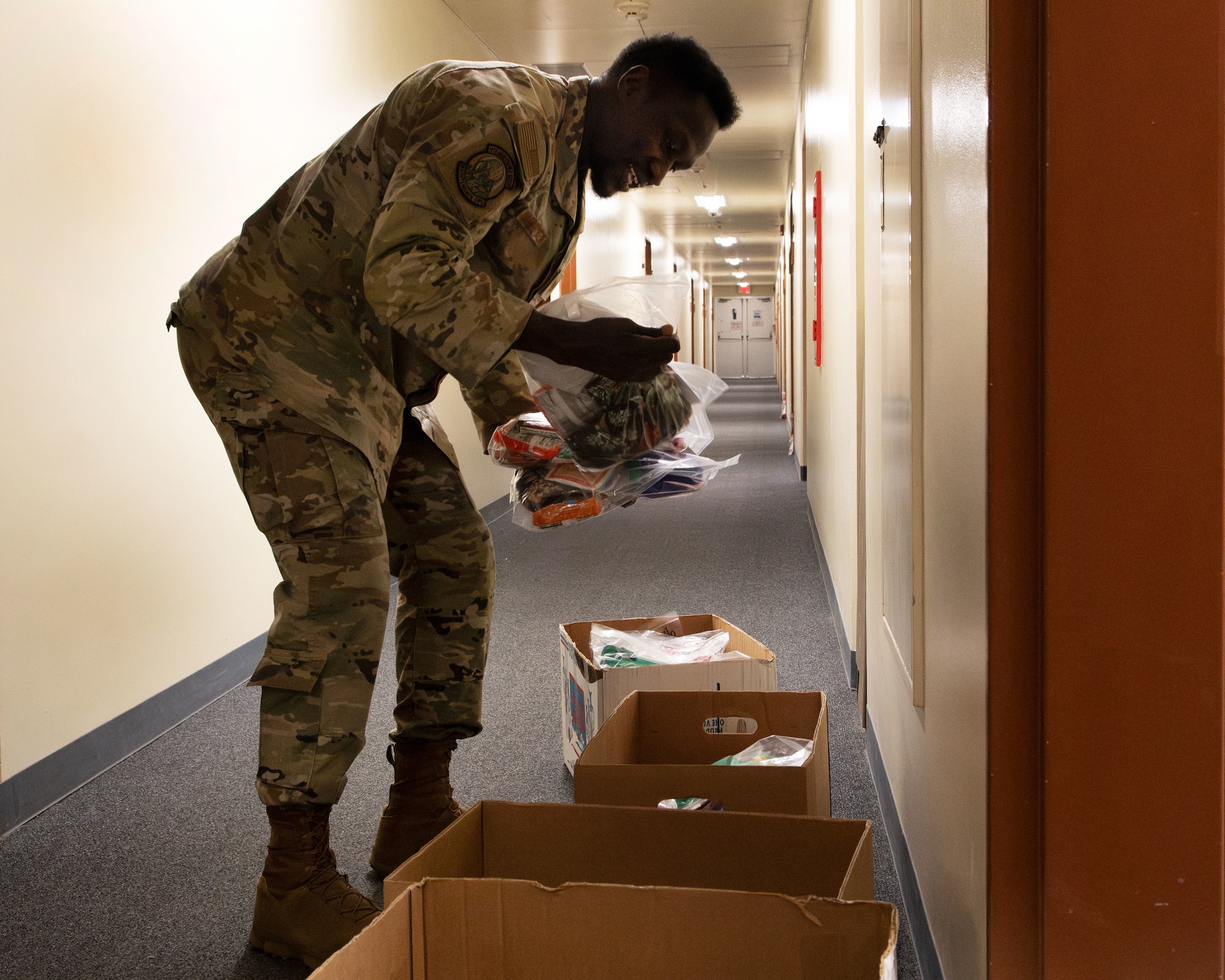 A U.S. Air Force service member unpacks gifts.
