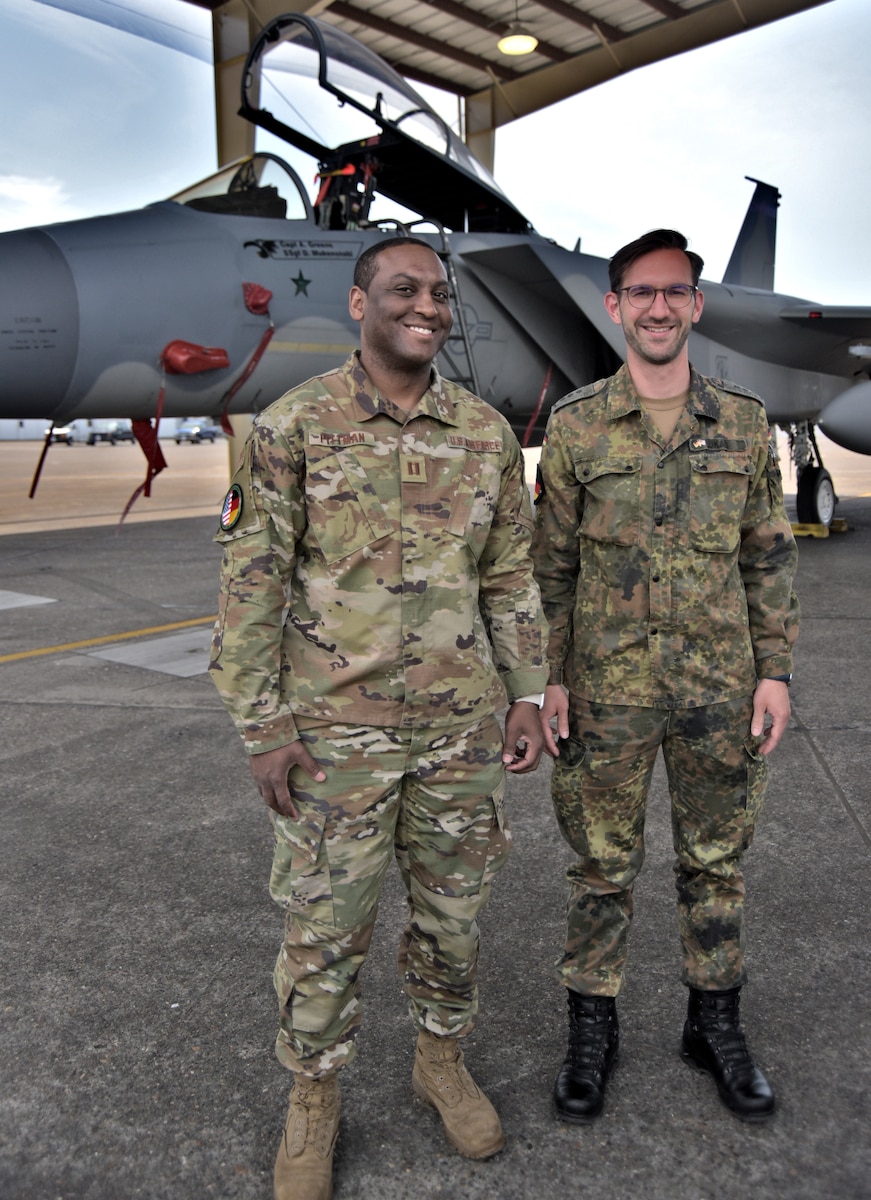 Capt. Philipp Lukas, right, of the German Reserve Air Force, and Capt. Dewayne Pittman of the 142nd Aircraft Maintenance Squadron, Oregon Air National Guard, pose in front of a 142nd Wing F-15C Eagle at the Portland Air National Guard Base, Portland, Ore. The two officers participated in an exchange program sending Lukas to Oregon and Pittman to Germany.