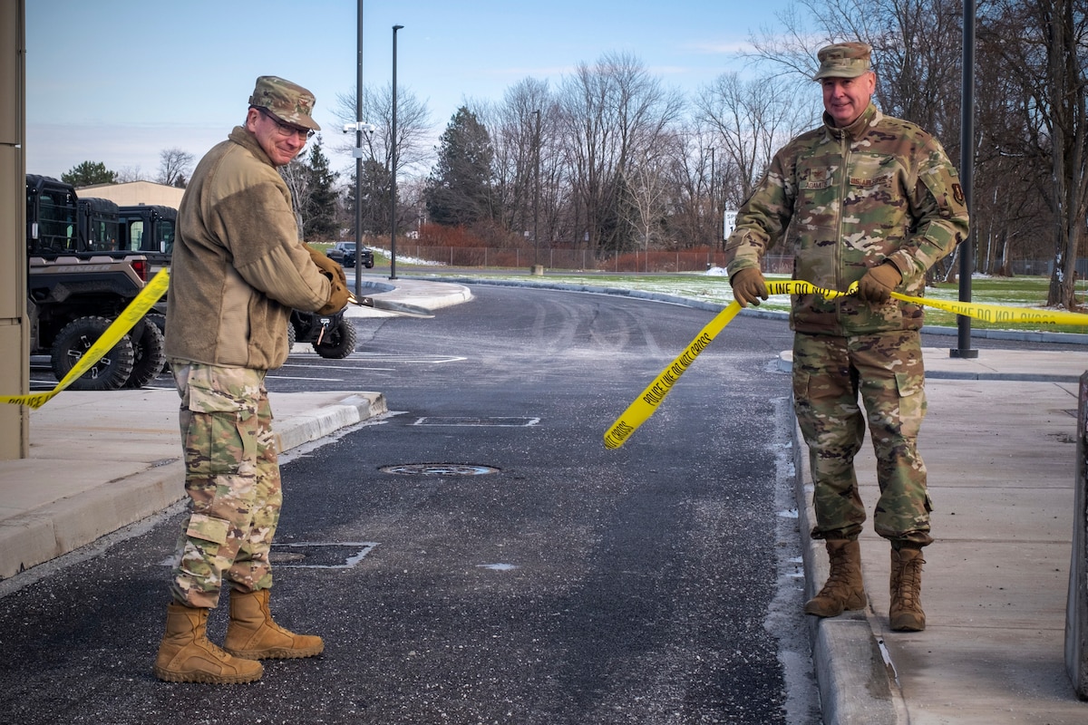 U.S. Air Force Col. John O'Connor, 174th Attack Wing commander, and Col. Michael Adamitis, 174th Mission Support Group commander, cut the ribbon on the new Hancock Field Air National Guard Base main gate, Dec. 14. The new $4.5 million infrastructure will benefit the uniformed service members and civilian employees of Hancock Field. (U.S. Air National Guard by Alexander Rector)