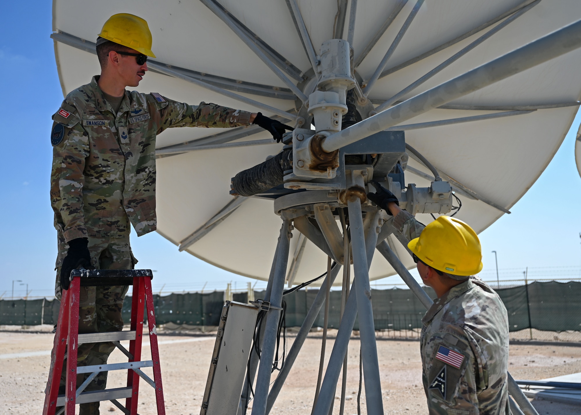 U.S. Space Force Sgt. Mitchell Swanson, left, 5th Space Warning Squadron Detachment 2 systems evaluator, and U.S. Space Force Capt. Steven Torres, right, 5th SWS Detachment 2 commander, inspect a ground antenna at an undisclosed location in the U.S Central Command area of responsibility, Oct. 27, 2023. The 5th SWS Detachment 2 was recently activated to assume the Joint Tactical Grounds Station mission from the U.S. Army. (U.S. Air Force photo by Senior Airman Sarah Williams)