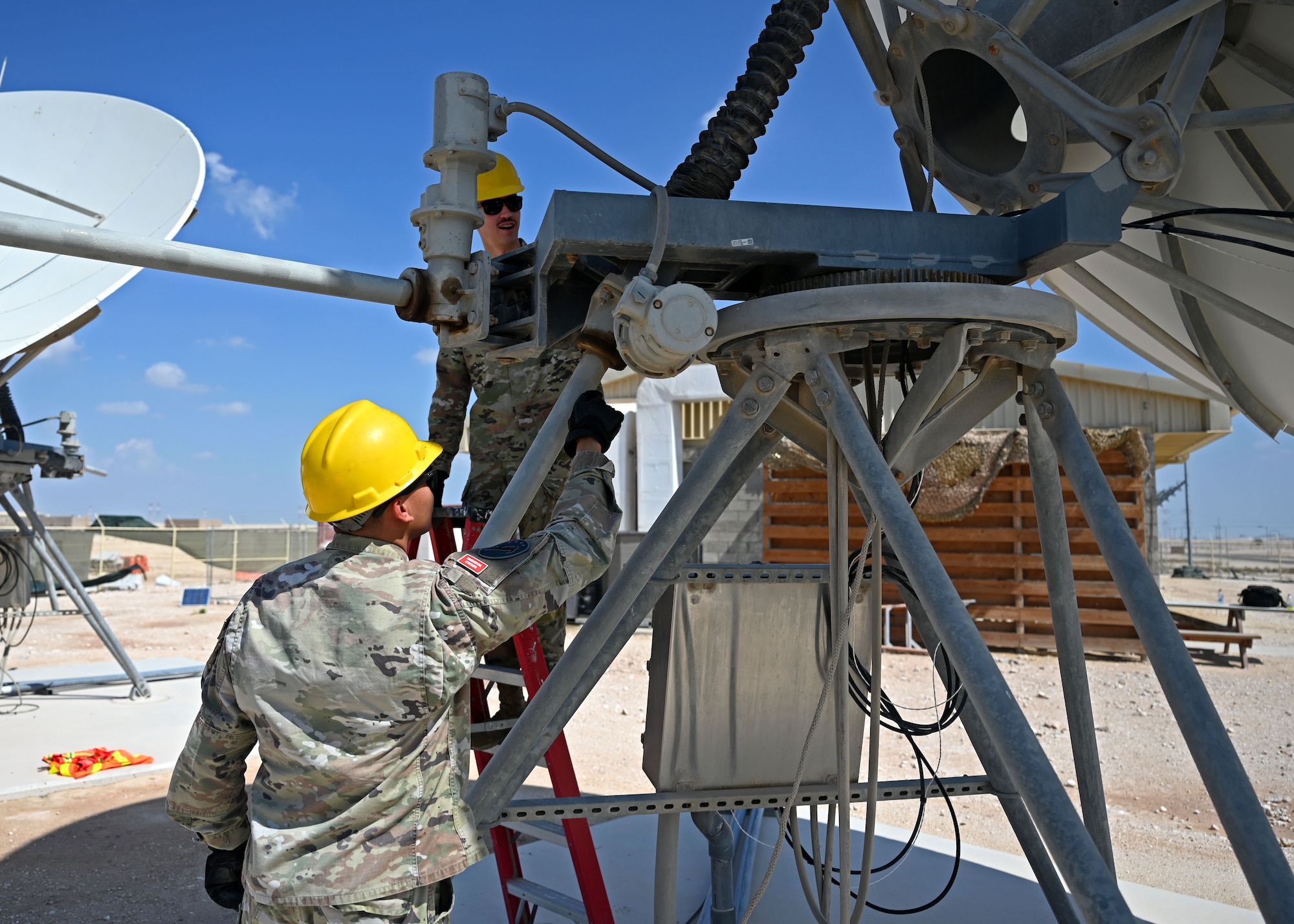 U.S. Space Force Capt. Steven Torres, left, 5th Space Warning Squadron Detachment 2 commander, and U.S. Space Force Sgt. Mitchell Swanson, right, 5th SWS Detachment 2 systems evaluator, inspect a ground antenna at an undisclosed location in the U.S Central Command area of responsibility, Oct. 27, 2023. Detachment 2 is one of four geographically separated units placed across the U.S. European Command, U.S. Central Command, and the U.S. Indo-Pacific Command acting as the eyes and ears for the U.S. military. (U.S. Air Force photo by Senior Airman Sarah Williams)