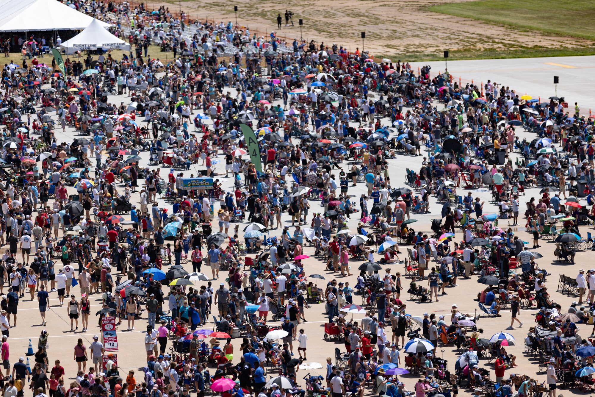 Crowds look up at the sky during aerial performances.