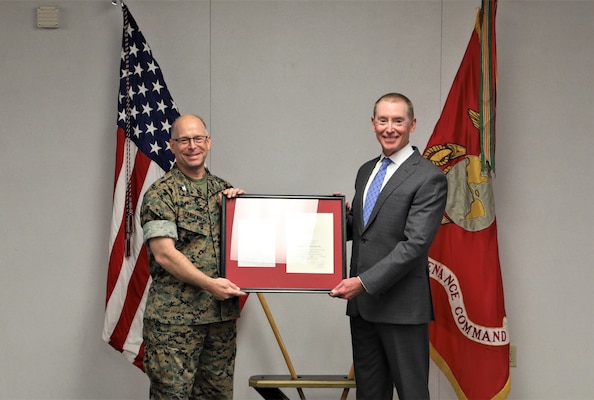 Mr. Robert "Chip" Schwartz, plant manager, Production Plant Barstow, receives a framed Length of Service award and letter from the commander, Marine Corps Logistics Command from Col. Kirk. M. Spangenberg, commanding officer, Marine Depot Maintenance Command during a retirement ceremony in Chips honor.  Schwartz has served at Marine Corps Logistics Base Barstow for 29 years, and as the Plant Manager for the Production Plant since 2015.