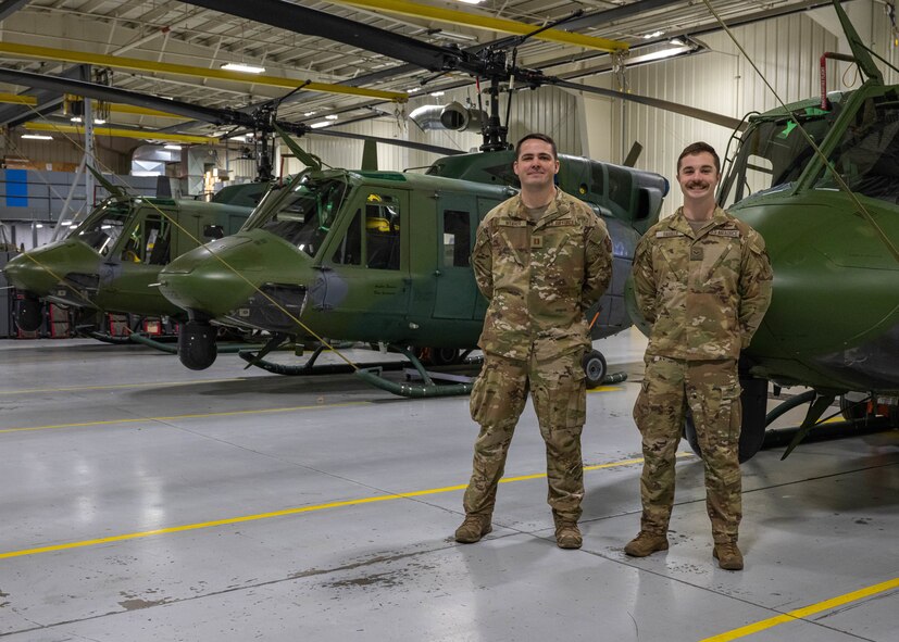 U.S. Air Force Capt. Matthew Weaver, 54th Helicopter Squadron (HS) aircraft commander (left), and Senior Airman Daniel Barker, 54th HS special missions aviator instructor, pose for a portrait at Minot Air Force Base, North Dakota, Dec. 20, 2023. The 54th HS provides integrated rapid security response capabilities to Team Minot. (U.S. Air Force photo by Airman 1st Class Kyle Wilson)
