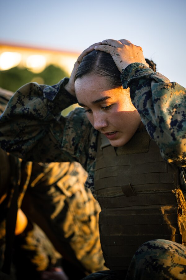 U.S. Marine Corps Cpl. Aaliyah Aguallo, an administrative specialist with Installation Personnel Administration Center, Marine Corps Installations Pacific, performs a duck walk during the culminating event of a Martial Arts Instructor Course on Camp Hansen, Okinawa, Japan, Dec. 14, 2023. The MAI course is a three-week course that implements physical training and academic instruction for instructor trainees. The demanding physical intensity prepares trainees to perform Marine Corps Martial Arts Program techniques through the different elements of war. Coursework evaluations ensure that all newly graduated instructors have more than enough knowledge to carefully supervise and instruct Marines who are looking to make MCMAP belt advancements. Aguallo is native of Chicago, Ill. (U.S. Marine Corps photo by Cpl. Thomas Sheng)