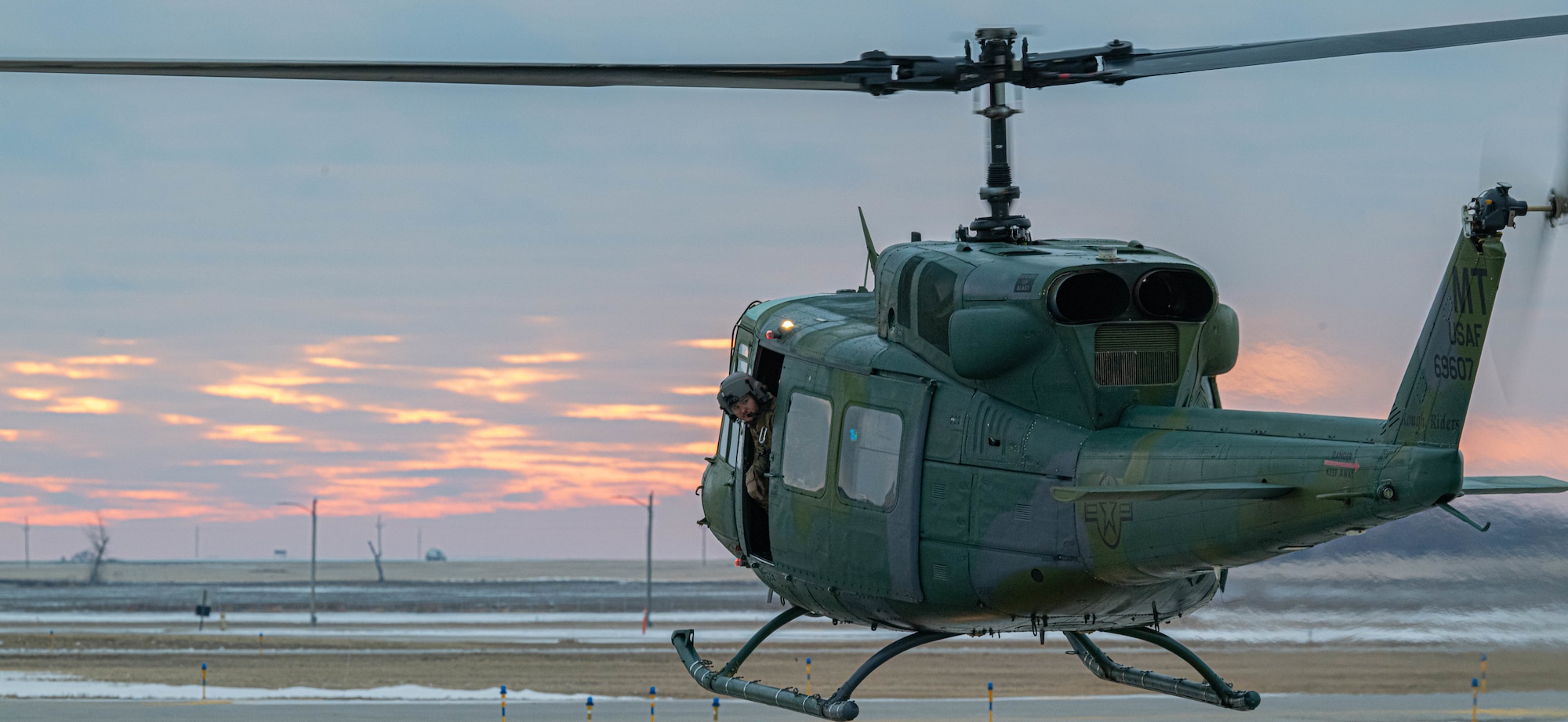 A U.S. Air Force UH-1N Iroquois, assigned to the 54th Helicopter Squadron, takes off at Minot Air Force Base, North Dakota, Dec. 20, 2023. The UH-1N is a light-lift utility helicopter used to support a wide variety of missions. (U.S. Air Force photo by Airman 1st Class Kyle Wilson)