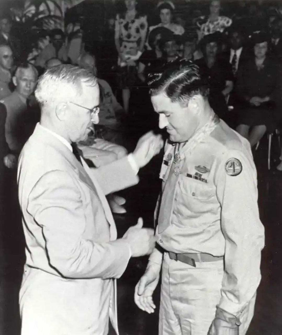 One person shakes another’s hand.