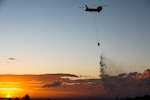 A Hawaii Army National Guard CH-47 Chinook drops water on wildfires in Ka’anapali, Maui, Aug. 26, 2023.