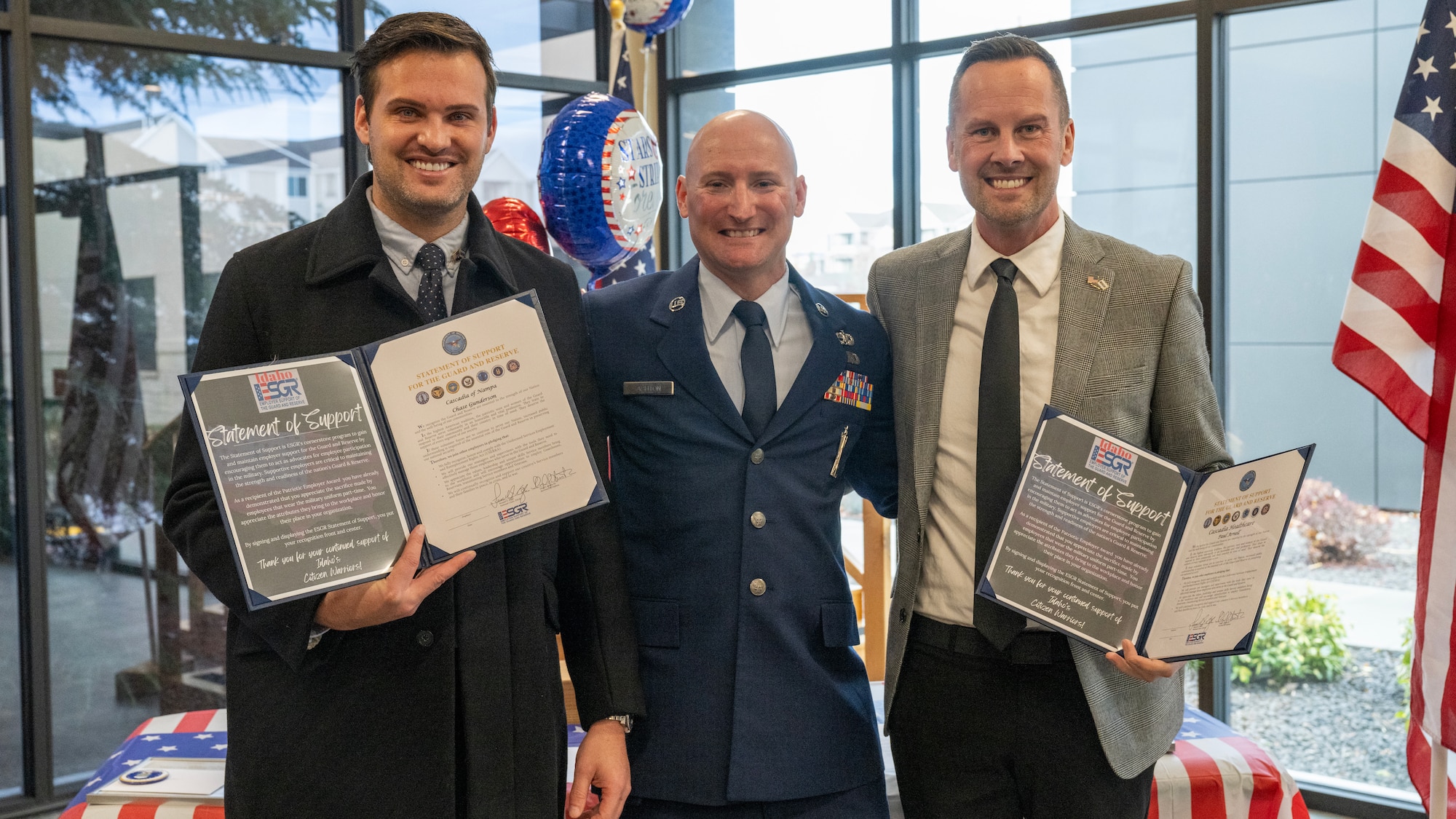 From left to right, Chase Gunderson, executive director of Cascadia of Nampa, Tech. Sgt. Mike Ashton, a commander support staff Airman with the 124th Fighter Wing, and Paul Arnell, president of Cascadia of Nampa, pose for a photo after an Employer Support of the Guard and Reserve Patriot Award ceremony